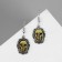Skull earrings, golden color in black silver