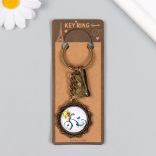A metal keychain, glass with a carbine 