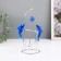 Dolphins pendulum opposite each other with a ball of 9 x 15 x 19.5 cm