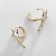 Cooping earrings melting star, white color in gold, d = 2 cm
