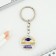 A keychain for graduation "graduate", diam. 3 cm