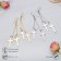 Earrings hanging "rustle" crosses, color mix, 8.5 cm