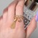 Ring "Brush" with bead, white color in gold, dimensionless