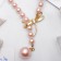The necklace is “pearl” with a flipping element, dragonfly, pink color in gold, 50 cm