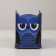 The stand for the office is a wooden owl "owl, winks", with a print, blue