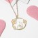 Children's pendant "chosen" cat, white-pink color in gold