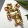 Brooch "Cat" Indian in flowers, colored in gold