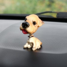 Dog on a car panel shocking his head, Wales Terrier