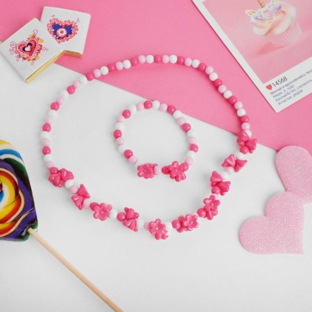 Children's “chosen” set 2 objects: beads, bracelet, lilac flowers, pink color