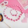 Children's “chosen” set 2 objects: beads, bracelet, lilac flowers, pink color