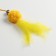 Domesticon-pound with a soft ball and feathers, yellow