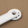 The fastener is sewn for a bag, on a button, made of genuine leather, 13.5 × 2.5 cm, white/silver color