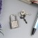 A hinged metal lock for caskets with a key of 3.3x1.9 cm