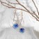 Hanging earrings with rhinestones "drop with a rhombus", the color is blue in pink gold