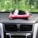 Toy on a car panel, a cat on a pillow, black and white color