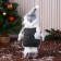 Soft toy "Snowman in the cap and scarf, long legs" stands, white-gray