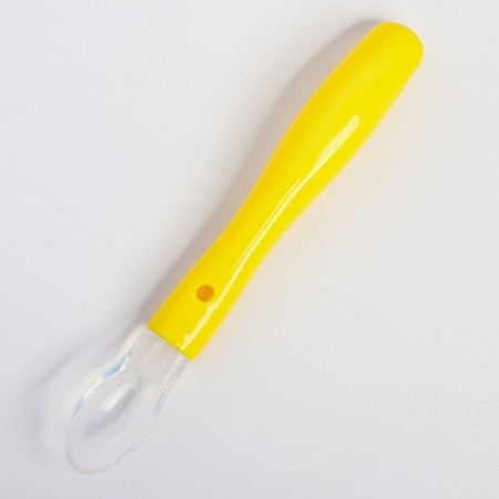 A spoon for nursery for feeding silicone, from 5 months, yellow color