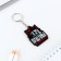 A wooden key keychain "Boys do not apologize", 5 x 3.6 cm