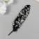 Feather of decorative pheasant "skull" black with silver h = 15-20 cm
