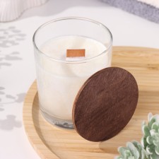 A candle made of soy wax in a glass with a wooden wick and a “delicate orchid” lid, 110 gr