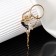 Brooch "Gymnast" with hool-hup, black and white color in gold