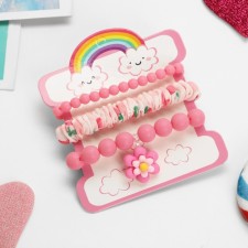 The kit of children's “chosen” 3 objects: elastic band, 2 bracelets, flower, pink matte color