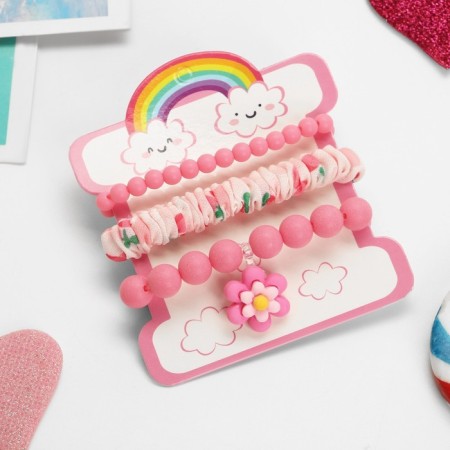 The kit of children's “chosen” 3 objects: elastic band, 2 bracelets, flower, pink matte color