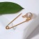 Classic pin, circle, 5 cm, white color in gold