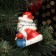 Fir -tree porcelain toy "Santa Claus with a clock", Red fur coat, 8 cm