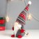 Interior doll "Santa Claus with ski sticks, a gray cap with patterns" 27x12x8 cm