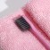 The toothbrush is soft, in the tube, pink