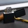 The gasoline lighter “Nobody except us”, 5.5 x 3.5 cm.