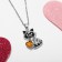 Children's pendant "chosen" raccoon, black-gold color in silver