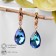 Earrings with rhinestones "Illusion" drop on oval, white-blue color in gold