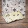A package with a hard bottom of 11 x 17 x 55 gold "snowflakes"