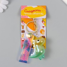 A plastic keychain with a carbine, a dinosaurus strap is green 2.5x5x5x5 cm