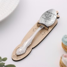 A teaspoon spoon with an engraving of 