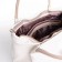The bag is female, medium size, long belt, white color