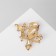Brooch "Eagle" on a branch, black and white color in yellow gold
