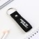 Kezzle keychain to the leatherette "First in everything!", 11 x 2.5 cm
