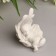 Polystone souvenir "Baby sleeping in the wing" White 8.7x6x5.5 cm