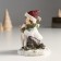 Polystone souvenir "Baby with a deer" red-green 7.8x8x10.3 cm