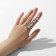 Ring "Assorted" volumetric claw, white color in silver, dimensionless