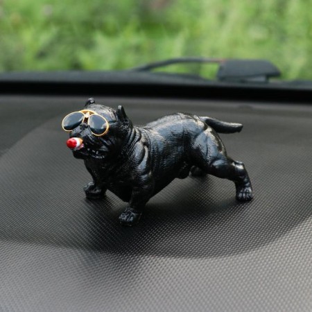 Dog on a car panel with suction cup for glass, bulldog