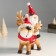 Suvenir Polystone "Santa Claus riding Oleska in a red cap and scarf" 8x14x23 cm