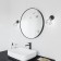 The mirror is round, black, diameter 55 cm