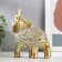 Souvenir Polystone "Golden Elephant with a Popone of Beads with bells" MIX 15x14.5x7.7 cm