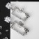 Earrings with rhinestones "flutter" butterflies in a rectangle, white color in silver