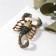 Brooch "Scorpio" in armor, black-green color in black gold