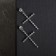 Earrings with rhinestones “crosses” with divisions, white color in silver